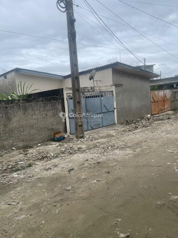 Terrain clôturé de 455 m² avec titre foncier personnel et bâtisses existantes